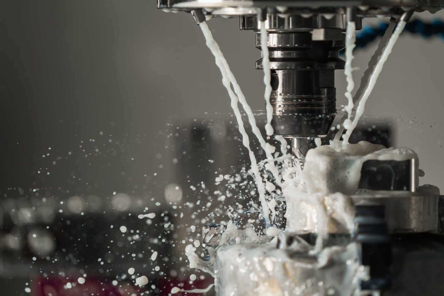 End mill cutting metal under coolant on a CNC machining centre